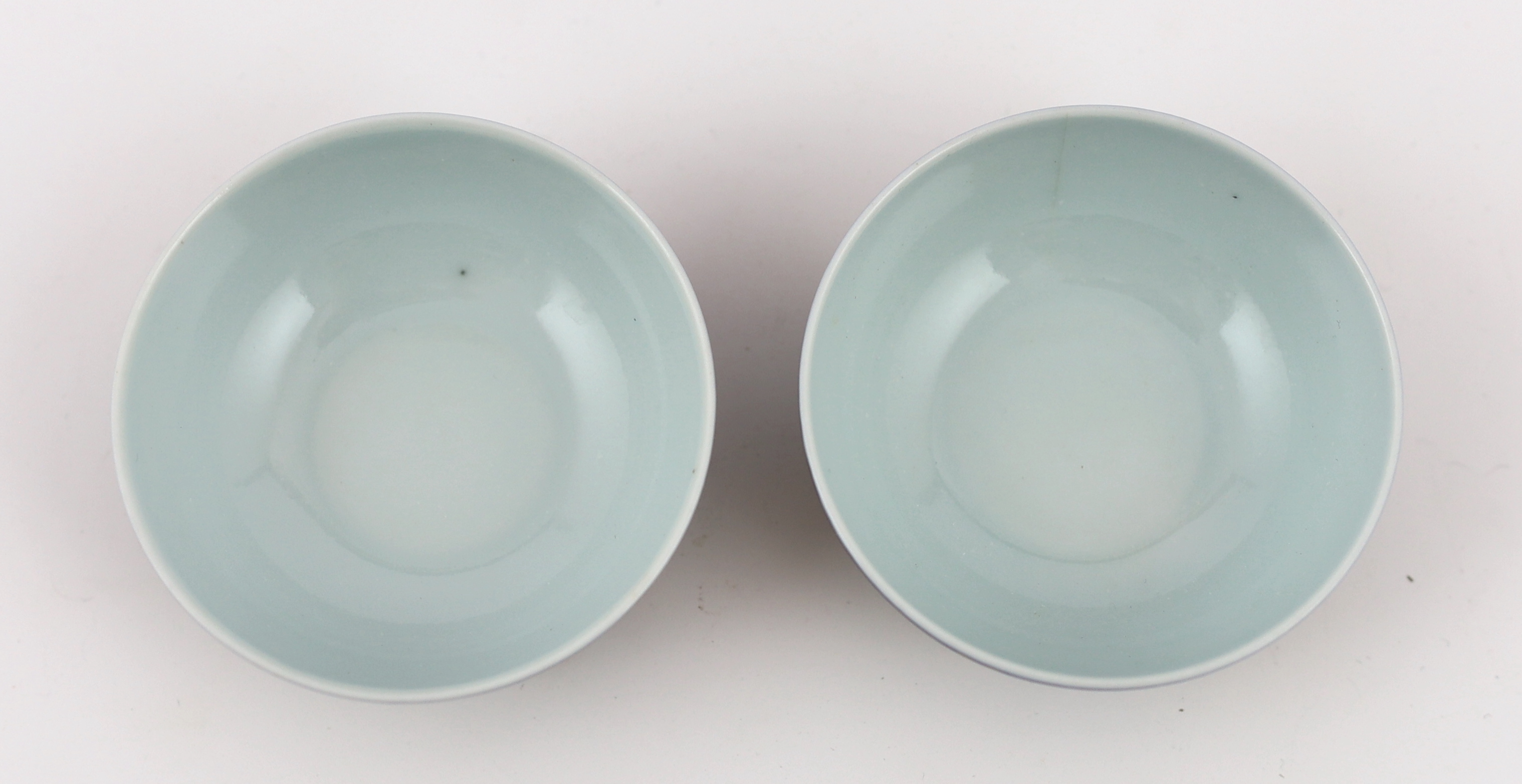 A pair of Chinese gilt decorated blue ground cups, Qianlong mark but later, one cracked
